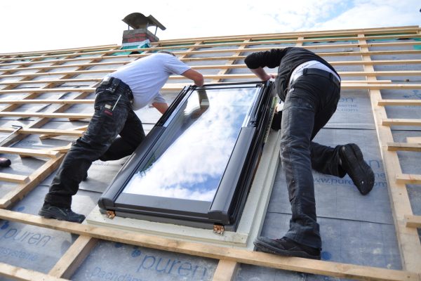 two-men-assembling-a-roof-skylight-window-2026-01-07-05-51-53-utc